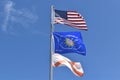 American flag Conch Republic Flag and State of Florida Flag flying against a blue sky Royalty Free Stock Photo