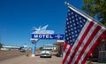 American flag covers a part of Motel Blue Swallow building and a pontiac car is parked at the entrance. Tucumcari, New Mexico, US