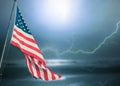 American flag on dark blue stormy sky. Royalty Free Stock Photo