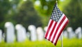 American flag displayed in front of cemetery headstones, AI-generated. Royalty Free Stock Photo