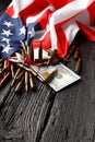 American flag, dollars, bullets, cartridges, ammunition on a black wooden background Royalty Free Stock Photo