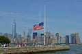 the american flag flies at half mast overlooking a city skyline