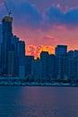 Boatside view of colorful sunset over the cityscape of Chicago and Lake Michigan.