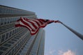 American flag fluttering in the wind against a skyscraper Royalty Free Stock Photo