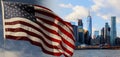 American flag flying the breeze against a blue sky New York, Brooklyn Bridge and Manhattan at the early morning sun light , New Yo Royalty Free Stock Photo