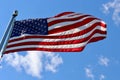 American flag flying in breeze from flagpole outdoors Royalty Free Stock Photo