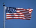 American Flag flying from flagpole Royalty Free Stock Photo