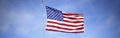 American Flag flying from flagpole Royalty Free Stock Photo