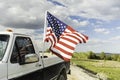 American flag flying on an old Ford truck and reflected on the window Royalty Free Stock Photo