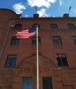 American flag in front of a red brick building Royalty Free Stock Photo