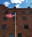 American flag in front of a red brick building Royalty Free Stock Photo