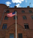 American flag in front of a red brick building Royalty Free Stock Photo