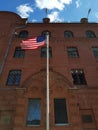 American flag in front of a red brick building Royalty Free Stock Photo