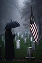 An American Flag on a Gravestone for Veteran\'s Day, Mourner with Umbrella