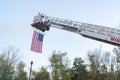 American flag hanging from fire truck ladder Royalty Free Stock Photo