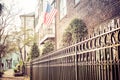 An American Flag hanging outside of a colonial era home Royalty Free Stock Photo