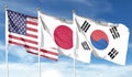 American flag with Japan flag and South Korea flag on cloudy sky. waving in the sky Royalty Free Stock Photo