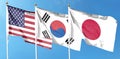 American flag with Japan flag and South Korea flag on cloudy sky. waving in the sky Royalty Free Stock Photo