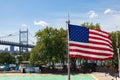 American Flag Flag and the Empty Astoria Park Pool during Summer with the Triborough Bridge in the Background in Astoria Queens