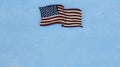 American flag laying flat on a blue background