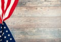 American flag lying on an aged, weathered rustic wooden background