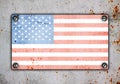 American flag on metal plate screwed screws on wall