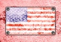 American flag on metal plate screwed screws on wall