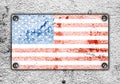 American flag on metal plate screwed screws on wall