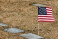 American Flag next to the graves at the cemetery.