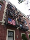 American Flag on a Brooklyn Fire Escape, USA Royalty Free Stock Photo