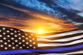 American flag with police support symbol Thin blue line on sunset sky. Royalty Free Stock Photo