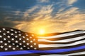 American flag with police support symbol Thin blue line on sunset sky.