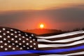 American flag with police support symbol Thin blue line on sunset sky. Royalty Free Stock Photo