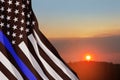 American flag with police support symbol Thin blue line on sunset sky. Royalty Free Stock Photo