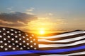 American flag with police support symbol Thin blue line on sunset sky. Royalty Free Stock Photo