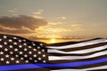 American flag with police support symbol Thin blue line on sunset sky. Royalty Free Stock Photo