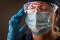 American Flag Reflecting on Distressed Female Medical Worker Wearing Protective Face Mask and Goggles Royalty Free Stock Photo