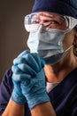 American Flag Reflecting on Distressed Praying Female Medical Worker Wearing Protective Face Mask and Goggles Royalty Free Stock Photo