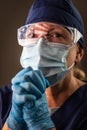 American Flag Reflecting on Concerned Praying Female Medical Worker Wearing Protective Face Mask and Goggles Royalty Free Stock Photo