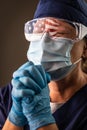 American Flag Reflecting on Distressed Praying Female Medical Worker Wearing Protective Face Mask and Goggles Royalty Free Stock Photo