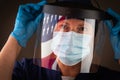 American Flag Reflecting on Female Medical Worker Wearing Protective Face Mask and Shield Royalty Free Stock Photo