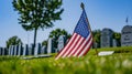 American Flag Resting in Grass at Cemetery Royalty Free Stock Photo