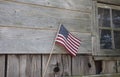 American flag on rustic wood cabin wall Royalty Free Stock Photo