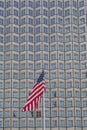 American flag set against skyscraper building windows in Downtown Miami, Miami, Florida Royalty Free Stock Photo