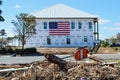 American flag on the side of a Hurricane Damaged Home