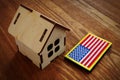 American flag and small house. VA mortgage loan concept