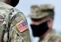 American flag on soldier arm and US soldiers wearing protective face masks. Quarantine in army. Military forces of the United Royalty Free Stock Photo