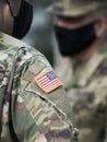 American flag on soldier arm and US soldiers wearing protective face masks. Quarantine in army. Military forces of the United Royalty Free Stock Photo