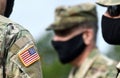 American flag on soldier arm and US soldiers wearing protective face masks. Quarantine in army. Military forces of the United Royalty Free Stock Photo