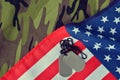 American flag and soldiers badges on camouflage fabric. Royalty Free Stock Photo